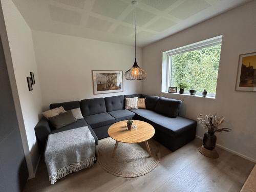 a living room with a couch and a table at Casa Jakobsen in Randers