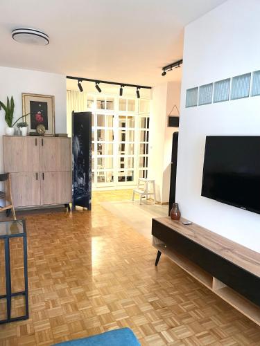 a living room with a large flat screen tv on a wall at Apartament Powiśle in Warsaw