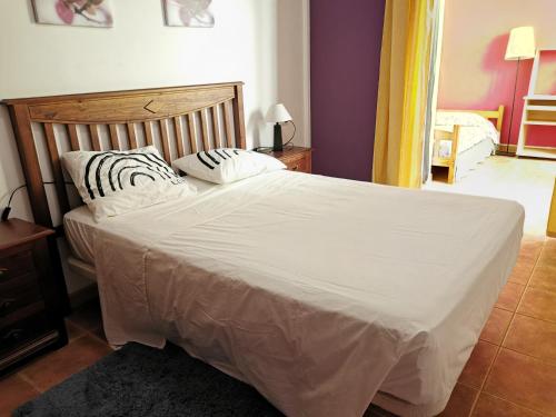 a bed with two pillows on it in a bedroom at Alma y Sol in La Caleta