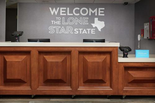 a welcomeelcome to the lone star state sign on a counter at Hampton Inn Beaumont in Beaumont