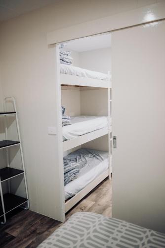 a closet with white bunk beds in a room at West View Caravanpark in Dubbo