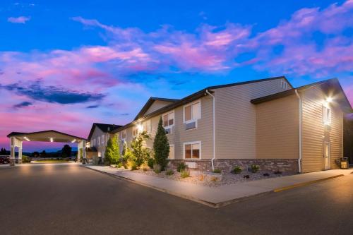 a rendering of a apartment building at dusk at SureStay Plus Hotel by Best Western Rexburg in Rexburg