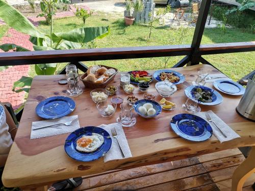 a wooden table with blue plates of food on it at Arlin Bungalows in Kemer