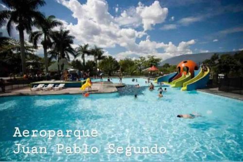 a pool at a resort with people in the water at Stefi house en Belén la mota Wifi in Medellín