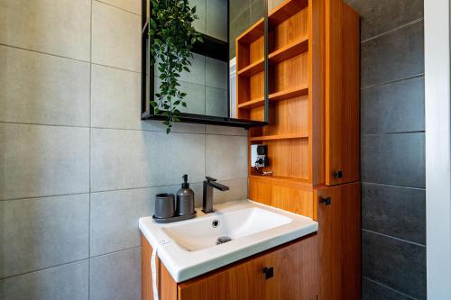 a bathroom with a sink and a mirror at CityHeart Studio in Bucharest