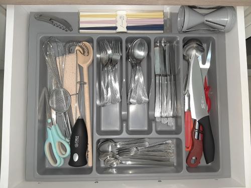 a drawer filled with utensils and utensils sidx sidx sidx at APARTMAN VIAGGIO i PARKING GARAŽA in Sremska Mitrovica