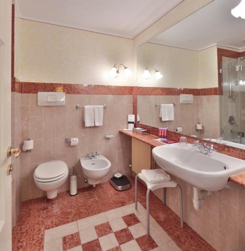 a bathroom with a toilet and a sink at TH Madonna di Campiglio | Golf Hotel in Madonna di Campiglio