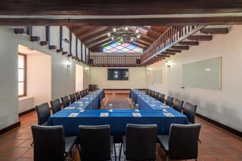 a large conference room with a blue table and chairs at San Jose de Puembo Quito Airport, an Ascend Collection Hotel in Puembo