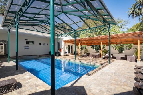 a pool with a pergola and a swimming pool at San Jose de Puembo Quito Airport, an Ascend Collection Hotel in Puembo
