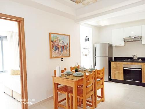 a kitchen with a table and chairs in a room at Hamza Boho Oasis in Essaouira