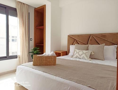 a bedroom with a large bed with a large window at Hamza Boho Oasis in Essaouira