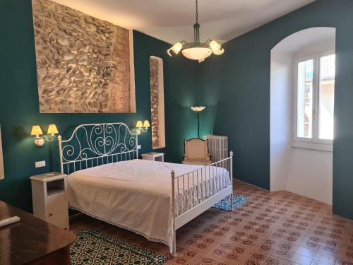 a bedroom with a bed and green walls at Corte Averaldo in San Felice del Benaco