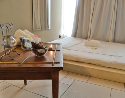 a bedroom with a bed and a table with a bowl of fruit at TH Madonna di Campiglio | Golf Hotel in Madonna di Campiglio