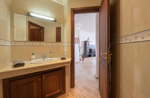 a bathroom with a sink and a mirror at APARTMENT HAY RYAD 200 M2 STANDIG in Rabat