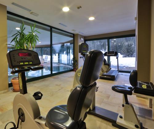 a gym with two treadmills and a treadmill at TH Madonna di Campiglio | Golf Hotel in Madonna di Campiglio