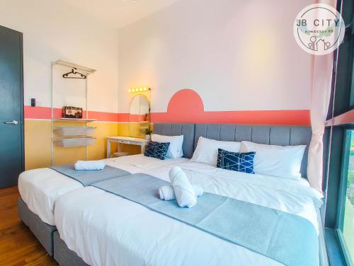 a bedroom with a large bed with white sheets at Skudai Paradigm Mall by RR JBcity in Johor Bahru