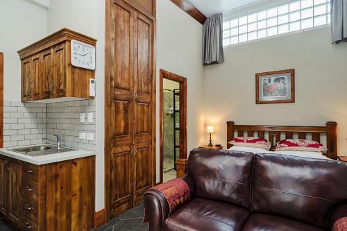 a living room with a couch and a bed at Eagle Foundry Bed & Breakfast in Gawler