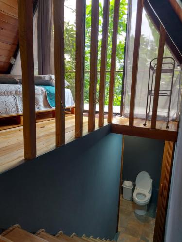 a tiny house with a toilet and a bunk bed at Toku in Fortuna