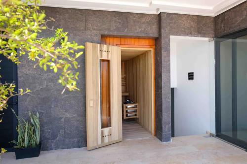 a hallway with a wooden door leading into a house at Stayon5a Av penthouse with PrivatePool in Playa del Carmen