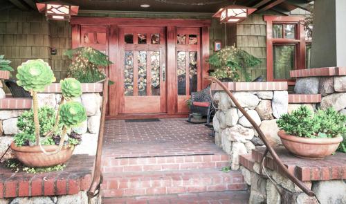 Blackbird Inn في نابا: باب أمام منزل به نباتات الفخار