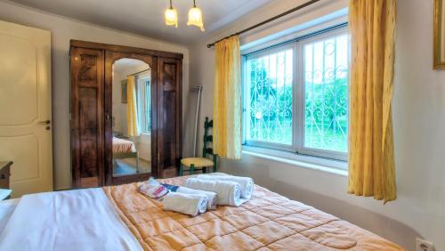 a bedroom with a bed with two towels on it at Villa Vivere in Corfu Town