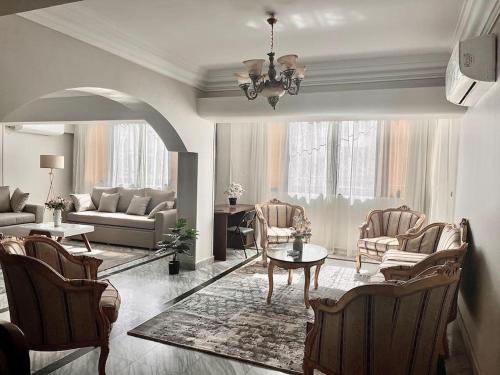 a living room with a couch and a table and chairs at Bright and spacious 2bdr apt للعائلات Nasr city heart in Cairo