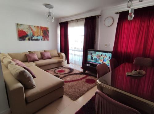 a living room with a couch and a tv at Madinty amazing view 2 rooms fully air-conditioned apartment at Madinty city for families only مدينتي in Madinaty