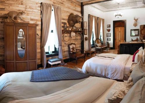 a bedroom with two beds and a mirror at Beard and Lady Inn in Chester