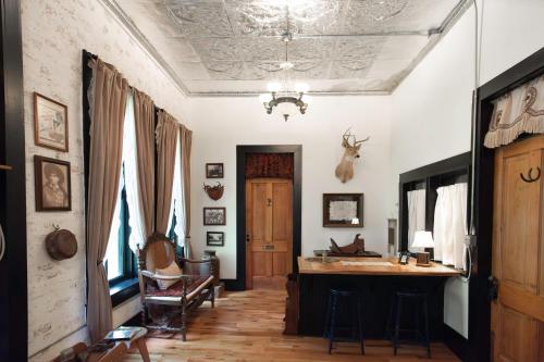 a living room with a table and a ceiling at Beard and Lady Inn in Chester