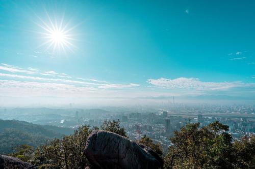 a view of a city with the sun in the sky at Hotel Indigo Taipei North by IHG in Taipei