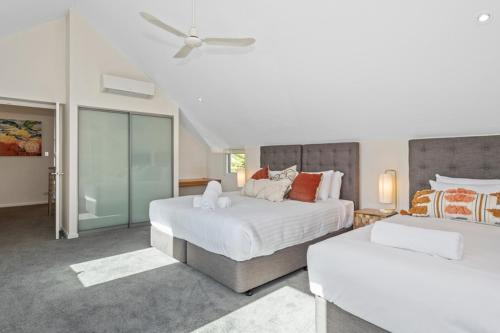 a bedroom with two beds and a ceiling fan at Beachside Bliss 2 Bedroom Family Villa in Mandurah
