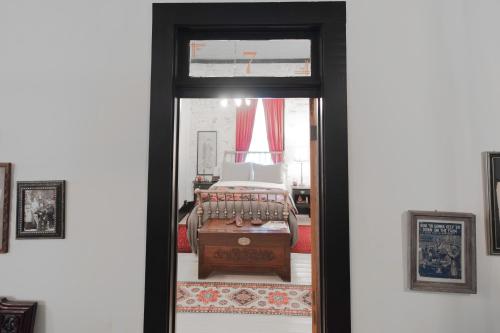a door leading into a bedroom with a bed at Beard and Lady Inn in Chester