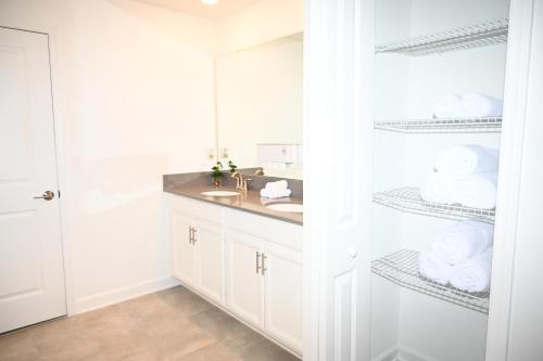 a bathroom with a sink and a mirror at Luxurious 8-Room Oasis near Disney in Kissimmee