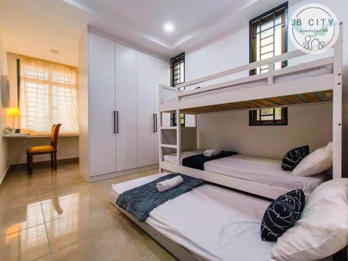 a bedroom with two bunk beds and a desk at Two-Nine Muslim Villa by RR JBcity in Johor Bahru
