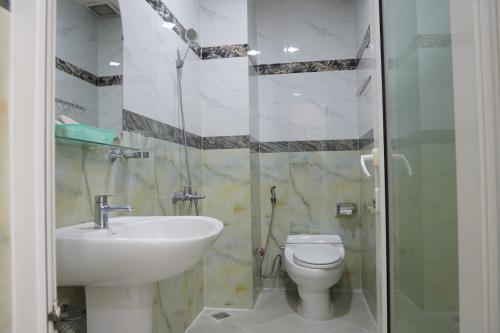 a bathroom with a sink and a toilet and a shower at kim'hotel near SECC - FV in Ho Chi Minh City