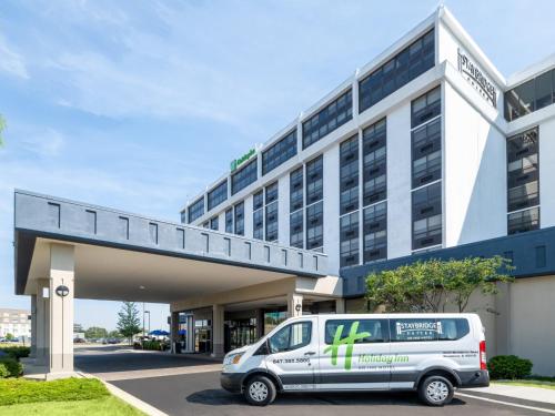 a van parked in front of a building at Holiday Inn Chicago O'Hare - Rosemont, an IHG Hotel in Rosemont
