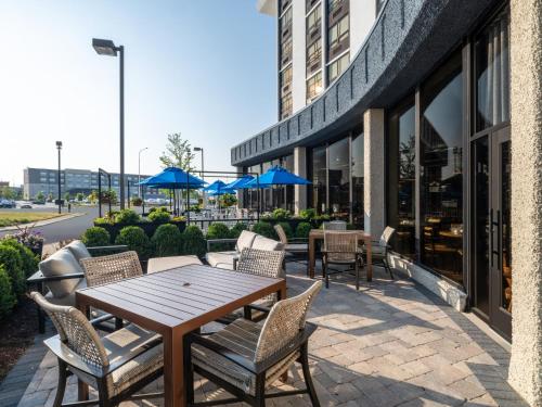 a patio with a wooden table and chairs at Holiday Inn Chicago O'Hare - Rosemont, an IHG Hotel in Rosemont