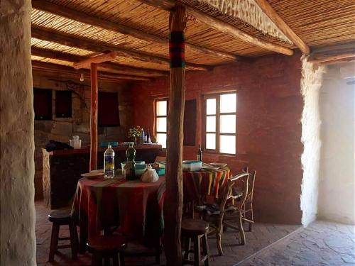 una sala da pranzo con tavolo e sedie in un edificio di Samary -wasi maragua a Estancia Chaunaca