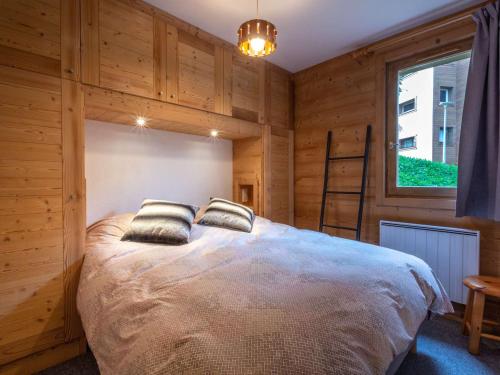 une chambre avec un lit avec deux oreillers dessus dans l'établissement Appartement familial 4 pièces, ski-in/ski-out, 8 pers, Méribel - FR-1-180-596, à Les Allues