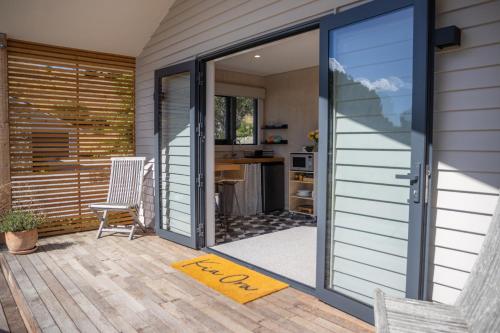 a sliding glass door on a patio with a desk at The Cottage - Springvale in Alexandra