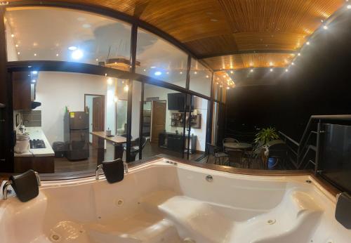 bañera grande en una habitación con espejo grande en San Simon Glamping,El peñol,Guatape, en Guatapé