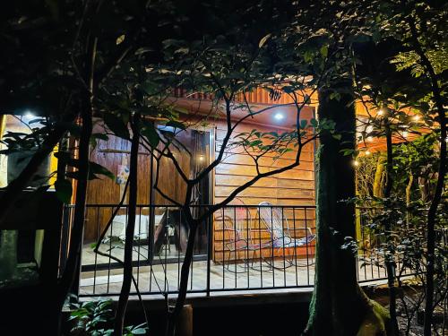 a gate in front of a house at night at Cabañas La Montaña in Monteverde Costa Rica