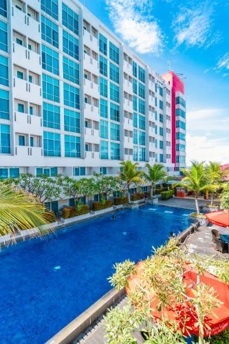 an image of a hotel with a large swimming pool at Swiss-Belinn Malang in Malang