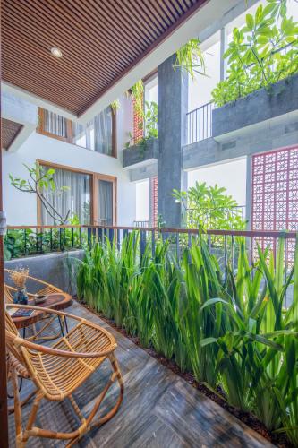 a patio with a table and a chair on a balcony at Bonny Boutique Hotel Da Nang in Da Nang