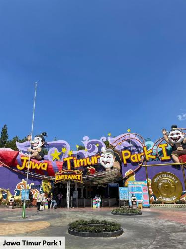 a theme park with a rollercoaster and attractions at Swiss-Belinn Malang in Malang