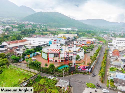 an aerial view of a city with mountains in the background at Swiss-Belinn Malang in Malang