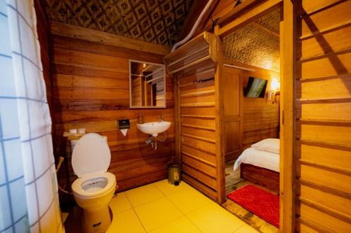 y baño con aseo y lavamanos. en Arkamaya Kusuma Resort en Yogyakarta
