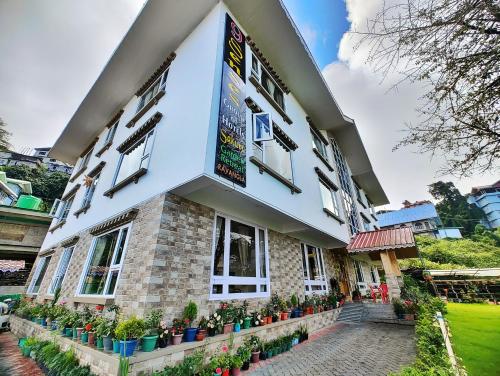 a building with plants in front of it at 9 Senses Group hotels , Ravangla in Ravangla