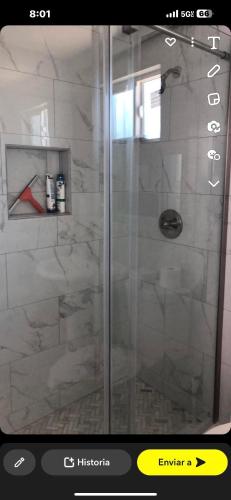 a shower with a glass door in a bathroom at Cerca aeropuerto in Mexico City