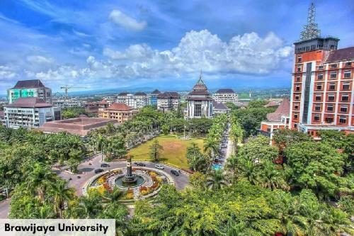 an aerial view of a city with buildings and a park at Swiss-Belinn Malang in Malang